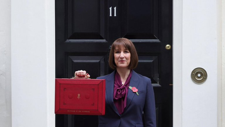 Image of Rachel Reeves holding the Redbox outside number 11 Downing Street